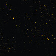 Vibrant image of countless golden particles scattered across a dark, black background, depicting energy, mystery, and celebration.