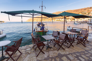 Wall Mural - Street cafe above the sea on the embankment of the village Symi.