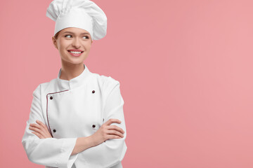 Canvas Print - Happy woman chef in uniform on pink background, space for text