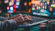 © nakarin - A person using a laptop or smartphone to engage in online gambling, with a screen displaying virtual casino games or sports betting odds.