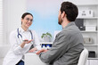 © New Africa - Doctor consulting patient during appointment in clinic