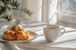 A cozy breakfast scene with croissants and a cup of coffee in morning light.
