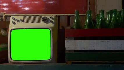Old Retro Television Turning On Chroma Key Green Screen in A Bar. Close Up. You can replace green screen with the footage or picture you want with “Keying” effect in After Effects.