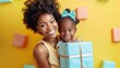 Beautiful pleased african american woman holding gift box and embracing daughter with happy mothers day