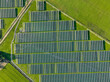 Solar panels on field in summer, aerial drone view