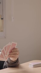 Wall Mural - Senior people and caregiver playing cards together in nursing home