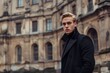© The Little Hut - Generative AI : Handsome trendy blond man standing outdoor in European city setting