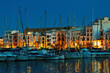 Yachts and illuminated houses in the evening in Ibiza.