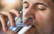 Healthy lifestyle concept. Man drinking clean water close-up, copy space