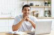 Content young African American man working or online education on laptop at home