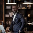 Relaxed yet assertive African American entrepreneur in modern workspace.