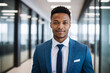 young age black businessman standing in hallway of modern office, glass and reflections, successful african american business man portrait, native corporate manager, assistant to ceo, starter newcomer