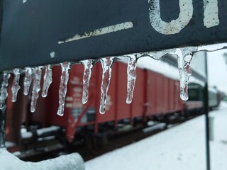 Closeup shot of small icicles hanging on a banner at a train station in Germany