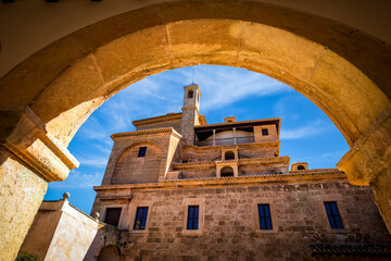 Poster - View of the top of the Basilica de la Vera Cruz in Caravaca de la Cruz, Murcia, Spain from one of the stone arches of the cloister