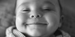 © Fotograf - A close up of a baby smiling with his eyes closed. Suitable for family and parenting concepts