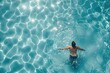 A person swimming in a clear blue pool. Suitable for lifestyle and health-related projects