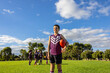 © Austockphoto - one boy in football uniform standing in front of his teammates holding a football