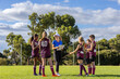 © Austockphoto - female coach with kids football team at training