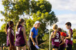 © Austockphoto - excited lady giving a pep talk to the kids she is coaching at football