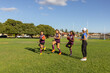 © Austockphoto - kids at football training with their female trainer