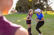 © Austockphoto - sports coach with schoolgirl on playing field