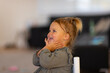 © Austockphoto - little girl with hands under chin smiling and looking out of frame