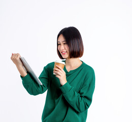 young asian woma holding digital tablet while holding coffee cup and standing, she is smiling lifest