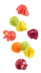 Wall Mural - Falling Colored fruity popcorn isolated on white background, full depth of field