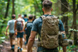 Rucking. Modern sport. People walk around the forest with backpacks filled with weights: dumbbells, kettlebells. Muscle training, endurance and cardio. Techniques borrowed from military training