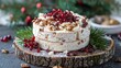   A tight shot of a cake adorned with nuts and cranberries atop a sliced piece of wood on the table