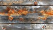   A tight shot of weathered wood, painted orange with flaking rust-hued patches