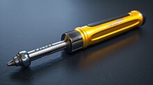 Shiny Yellow Metal Screwdriver For Repairing And Constructing On A Black Surface