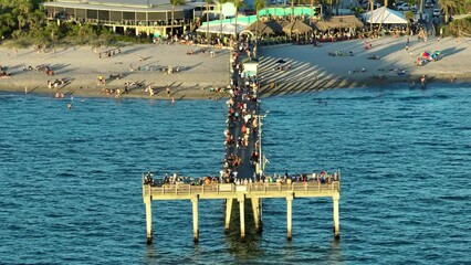 Canvas Print - People enjoying vacation time on Venice fishing pier in Florida. Seaside summer activities on fresh air