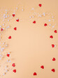 Background white pearls with red hearts on a gentle orange background with space for text