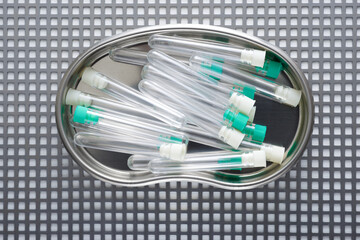 Wall Mural - Plastic test tubes on a metal tray