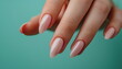 Soft pink almond-shaped nails on a blue background, great for fashion and gentle beauty portrayal