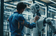 Handsome male engineer in a blue shirt repairing a white humanoid robot with tools at a modern factory