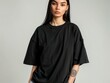© Dina - Stylish mockup of a plain black oversized t-shirt on a young woman, ideal for branding and design.
