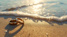 Wedding Rings On The Beach Sand