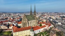Brno, Czechia. Roman Catholic cathedral. Originally medieval in gothic style, many renovations, High towers added in Gothic revival between 1901-1909. Aerial view. Spilberk castle in the background
