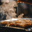 A close-up shot of a waffle iron with a fresh batch of waffle batter being poured onto the hot griddle, capturing the steam rising as the waffles cook to perfection.