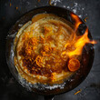 A top-down shot of a crepe Suzette being flambéed in a skillet with orange liqueur, creating a dramatic flame, with orange zest and caramelized sugar sprinkled on top.