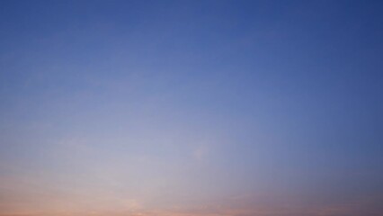 Wall Mural - The dramatic change in the sky as clouds roll and shift in a timelapse, from the warm hues of sunset to the cool tones of the evening. Weather concept. Stock footage. Time-lapse. Cloud background.

