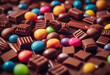 Assorted chocolates and colorful candy spread out in a close-up view, showcasing a variety of shapes and textures. International Chocolate Day.