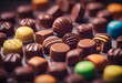 Assorted colorful chocolates with various fillings and designs, displayed in rows on a dark background. International Chocolate Day.