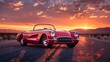 Vintage red convertible on a desert road at sunset