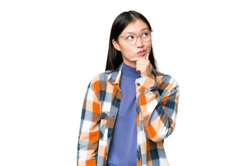 Wall Mural - Young Asian woman over isolated chroma key background having doubts and with confuse face expression