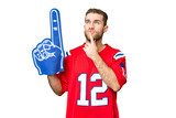 Fototapeta  - sports fan man over isolated chroma key background having doubts while looking up