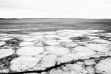 Fototapeta  - Ice drift in spring on Lake Onega, Karelia. Dangerous thin spring ice in April. Aggregate accumulations of fine-crystalline grains. Opening of small lakes, ponds and reservoirs. Crushed ice floes