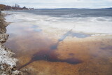 Fototapeta  - Ice drift in spring on Lake Onega, Karelia. Dangerous thin spring ice in April. Aggregate accumulations of fine-crystalline grains. Opening of small lakes, ponds and reservoirs. Crushed ice floes